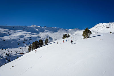Scenic view of snowcapped mountains against clear blue sky