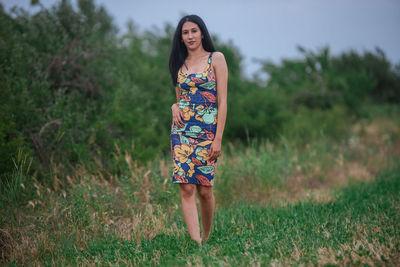 Portrait of woman standing on field