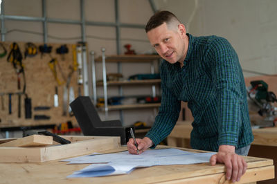 Side view of man working at workshop