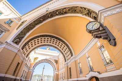 Low angle view of clock hanging on ceiling of building