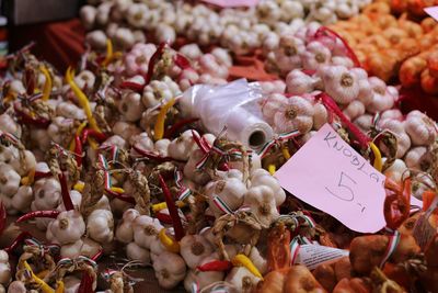 High angle view of fresh garlic cloves with label at market stall