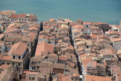 High angle view of townscape by sea