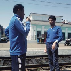 Full length of man standing on railroad track