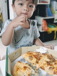 Full length of cute boy holding food