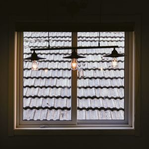 Low angle view of glass window hanging in building