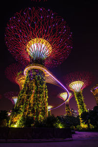 Low angle view of firework display at night