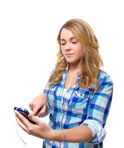 Young woman using mobile phone against white background