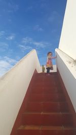 Low angle view of woman standing on staircase