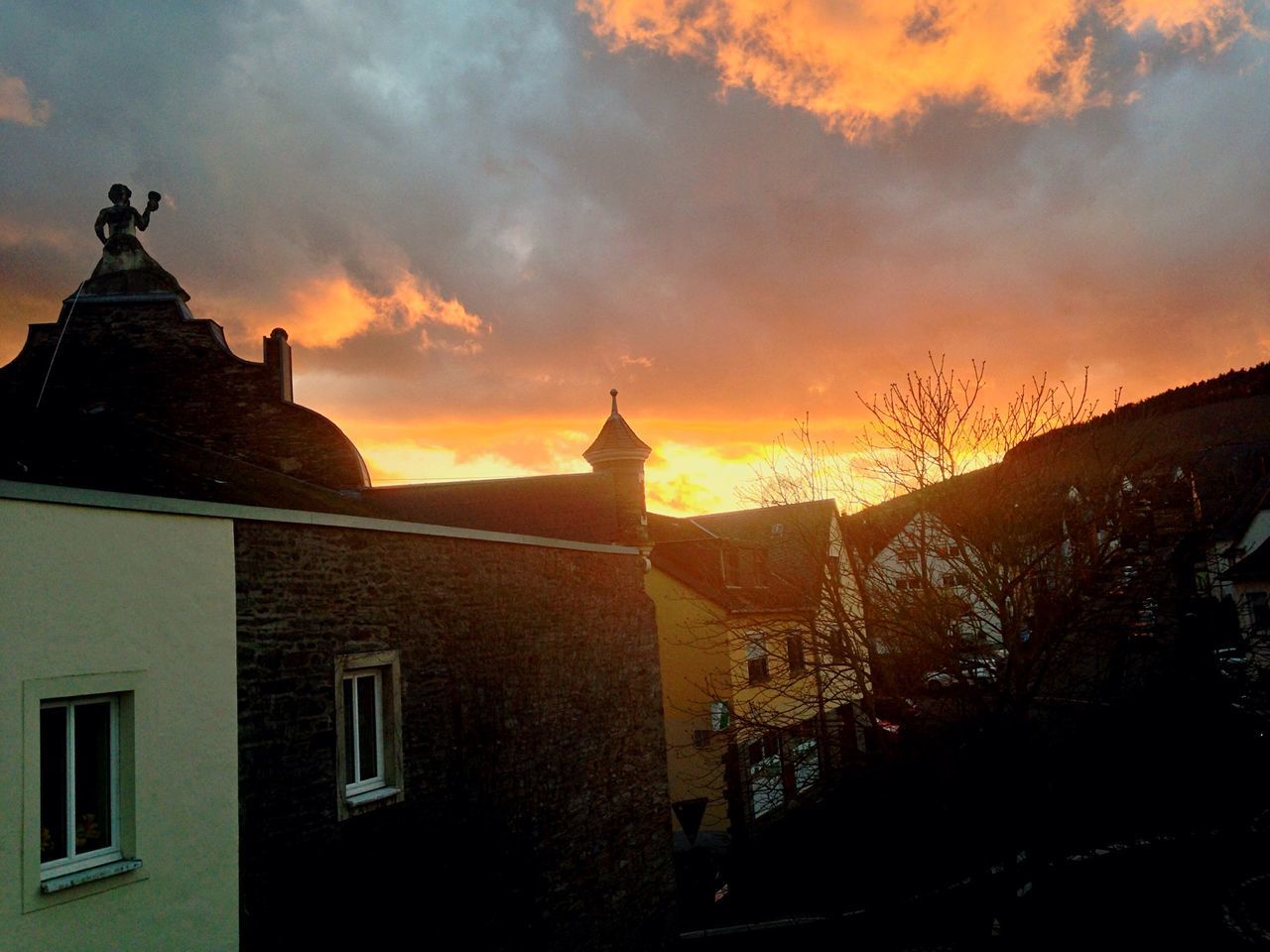 building exterior, sunset, architecture, built structure, sky, cloud - sky, orange color, religion, place of worship, spirituality, church, silhouette, house, cloudy, cloud, residential structure, outdoors, dusk