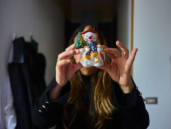 Woman showing snowman figurine