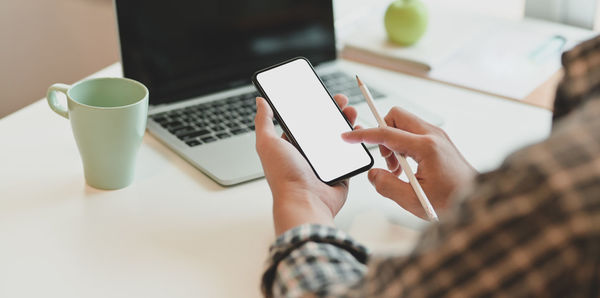 Midsection of woman using mobile phone