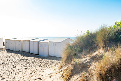 Beach hut against clear sky