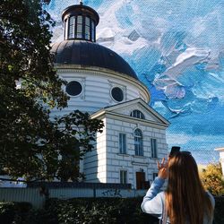 Woman in front of building