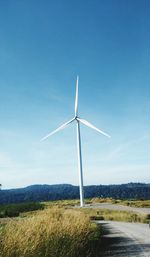 Windmill on field against sky