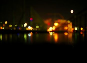 Reflection of illuminated lights in puddle