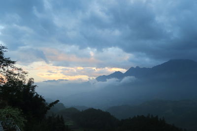 Scenic view of silhouette mountains against sky at sunset