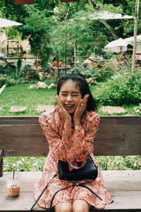 Portrait of smiling woman sitting on seat