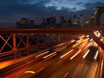 Illuminated bridge against sky at night