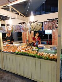 Woman standing at market stall