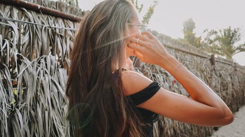 Backlit portrait from behind of a woman