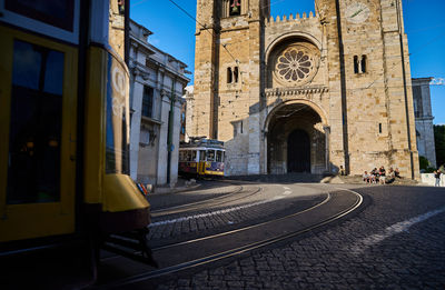 Railroad tracks amidst buildings in city