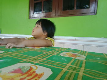 Portrait of a girl sitting on table