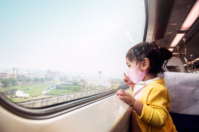 Boy looking through train window