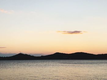 Scenic view of sea against romantic sky at sunset