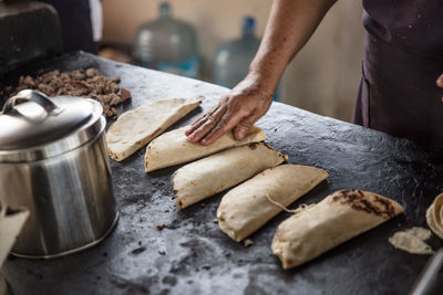 Midsection of man preparing food in kitchen