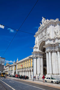 View of city street against blue sky