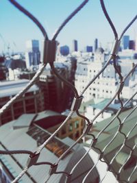 Close-up of chainlink fence against sky