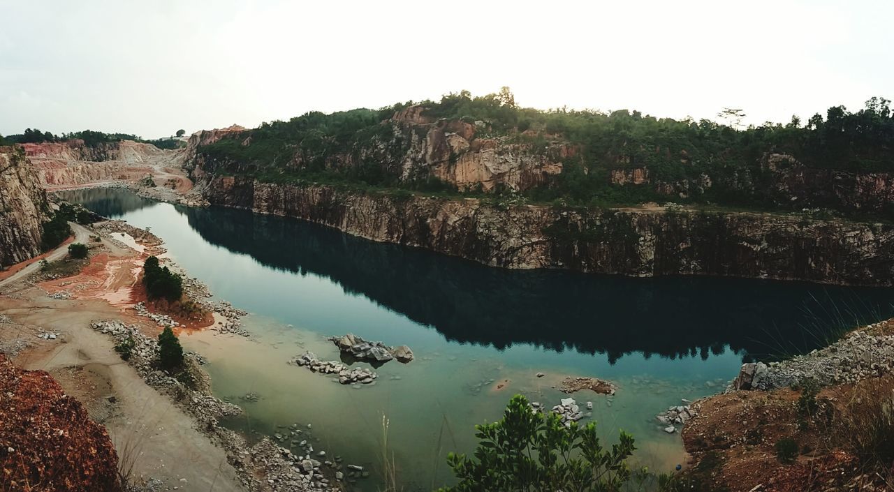 water, reflection, tree, tranquility, tranquil scene, scenics, lake, beauty in nature, nature, clear sky, sky, rock - object, standing water, idyllic, day, outdoors, river, rock formation, high angle view, mountain