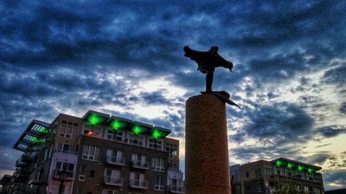 Low angle view of building against cloudy sky