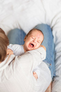 High angle view of baby boy crying at home