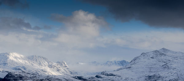 Scenic view of snowcapped mountains against sky