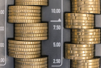 Close-up of stacked coins in cash box