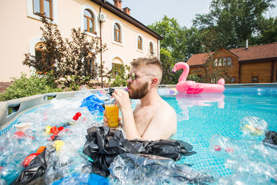 Full length of shirtless man in swimming pool