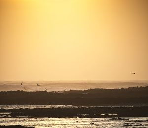 Scenic view of sea against sky during sunset