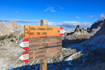 Information sign on rock against sky