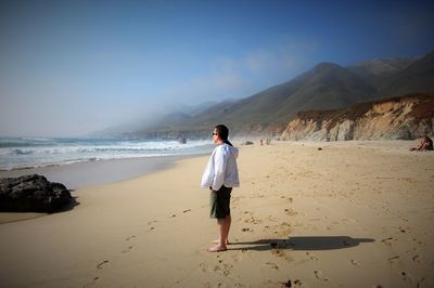 Full length of woman standing on beach