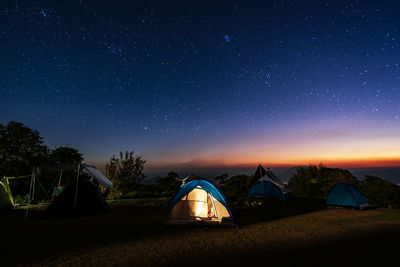 Tent on field against sky at night