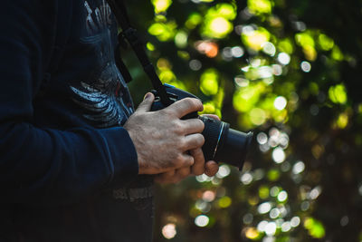 Close-up of man holding camera 