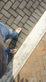 Low section of man standing on footpath