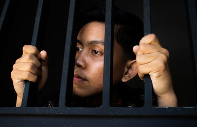 Portrait of man looking through window