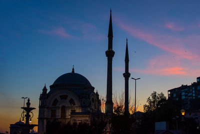 Low angle view of building against sky during sunset