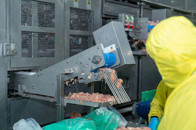 Chicken meat load out from automate cutting machine in modern process line.
