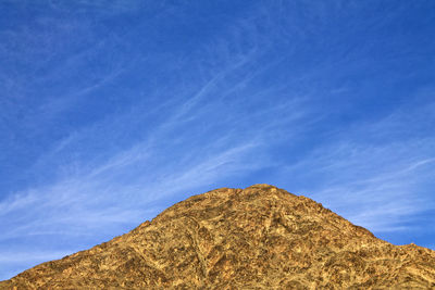 Low angle view of rock formation against sky