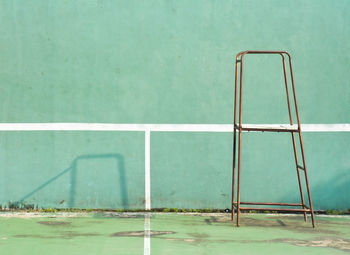 Metallic ladder against wall