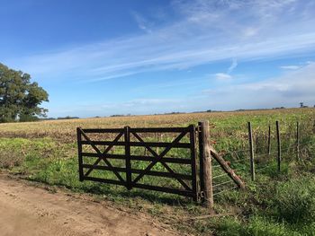 Fence on field against sky