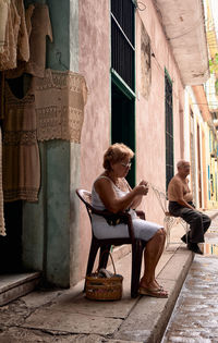 Woman sitting on chair outside outdoors